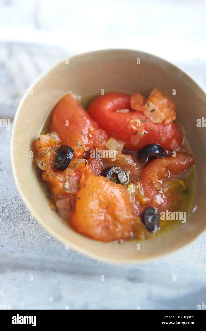 Roast garnished tomatoes melted in olive oil Stock Photo