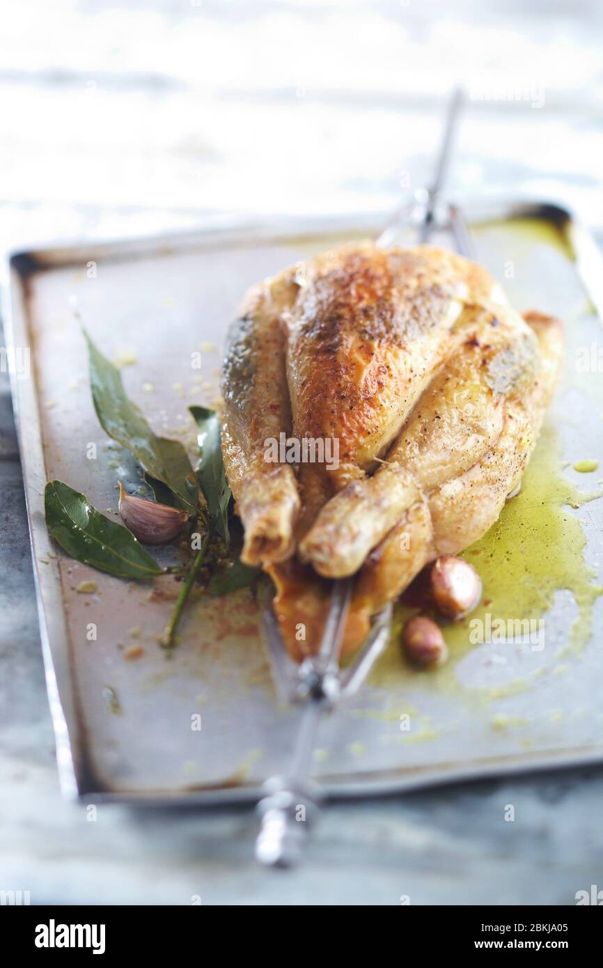 Roast chicken with bay leaves on a spit Stock Photo Alamy