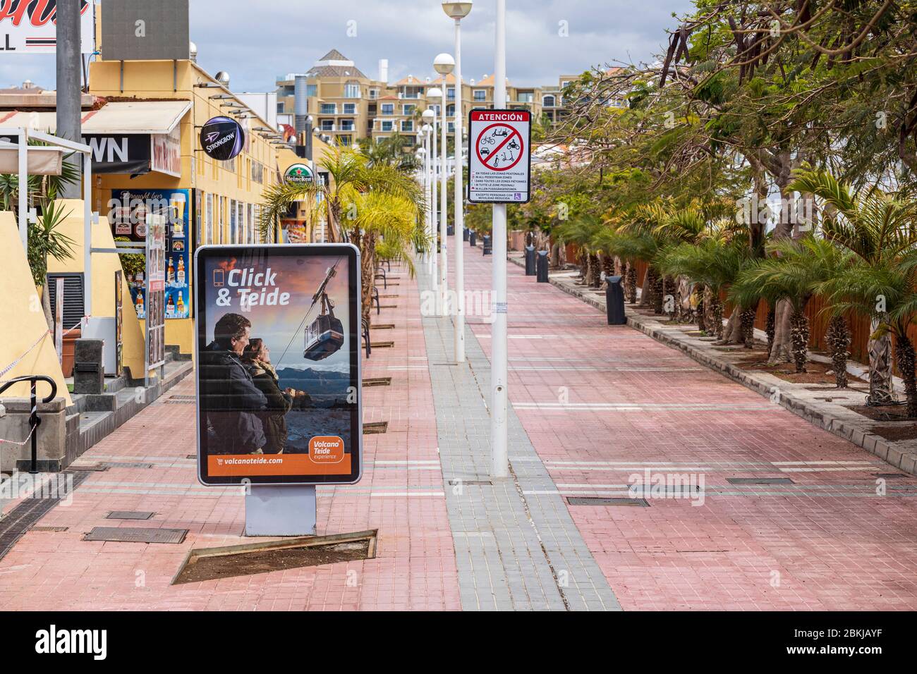 Advertising trips to Teide poster on the deserted promenade at Fanabe during the covid 19 lockdown in the tourist resort area of Costa Adeje, Tenerife Stock Photo
