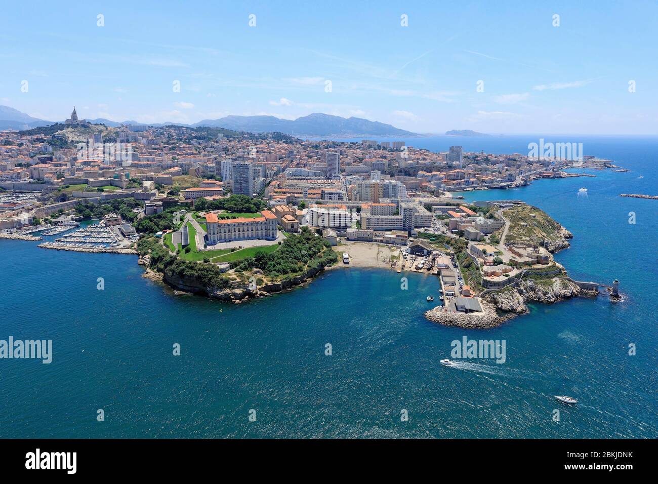 France, Bouches du Rhone, Marseille, 7th arrondissement, Pharo district, Pharo palace and Pharo cove, Pointe du Pharo, Notre Dame de la Garde basilica in the background (aerial view) Stock Photo