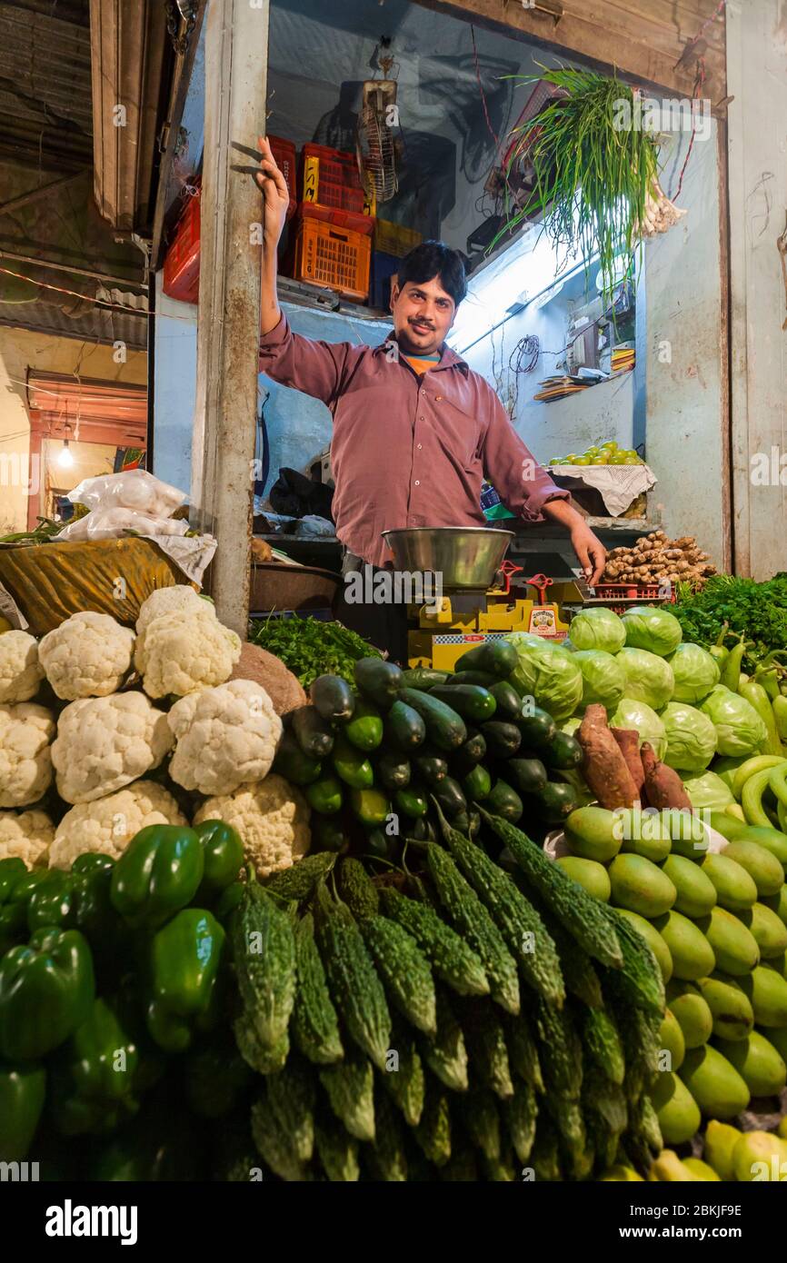 India, Rajasthan, Bikaner, shopkeeper proudly posing in front his vegetable stall Stock Photo