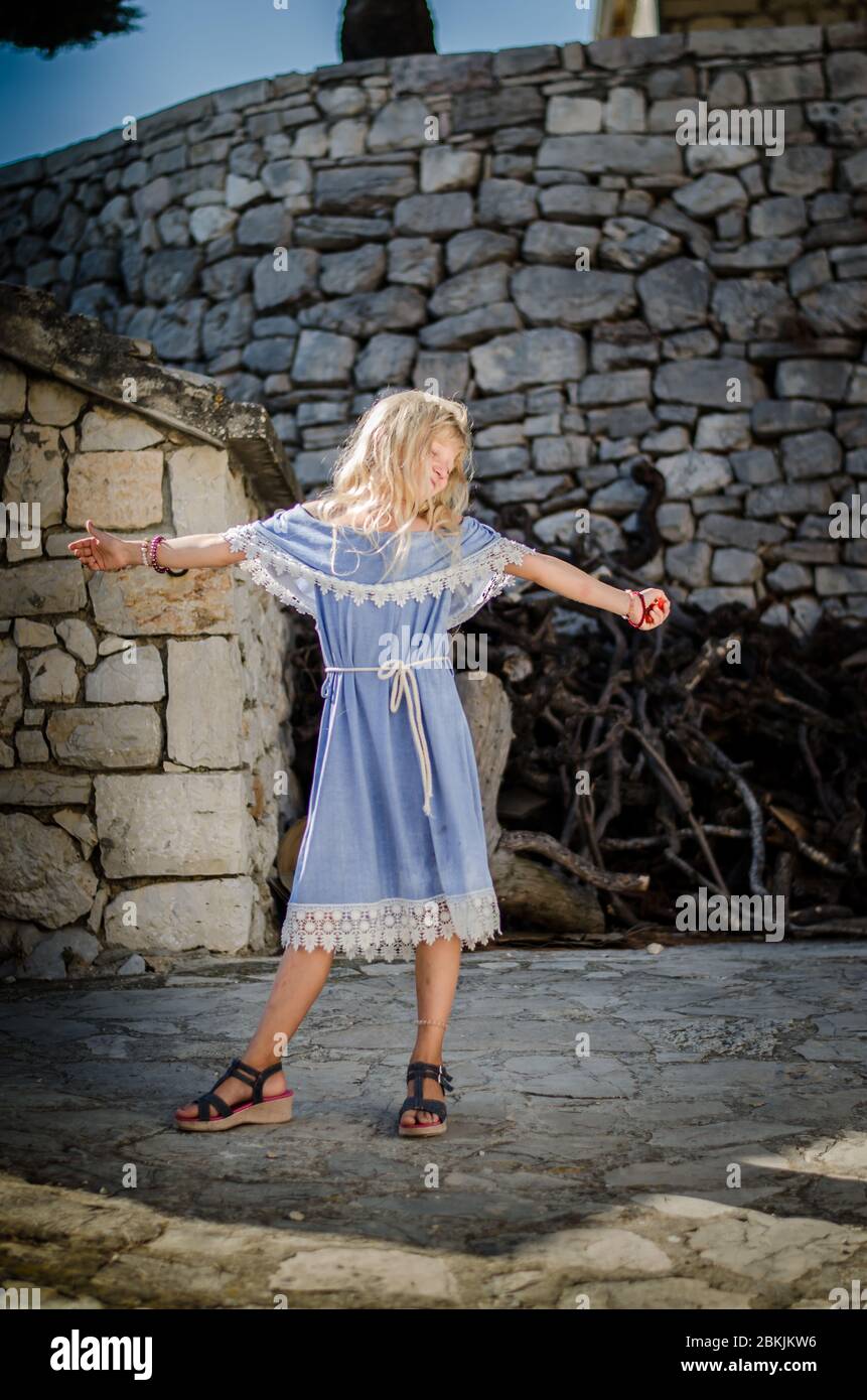 little-lovely-child-with-wavy-hair-in-blue-dress-posing-in-the-croatian