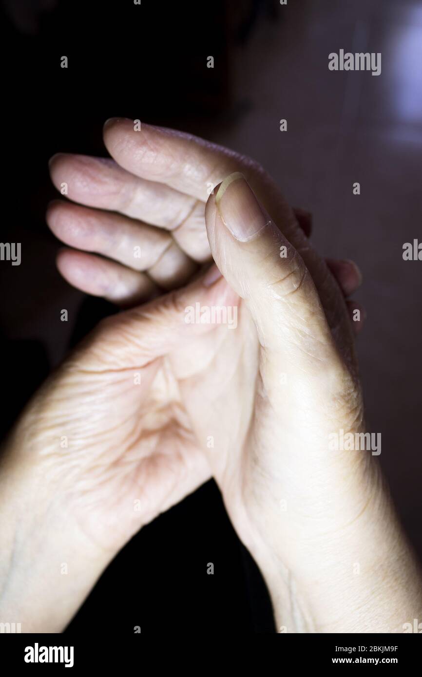 Hands of elderly woman doing a selfmassage. Manual physiotherapy Stock Photo