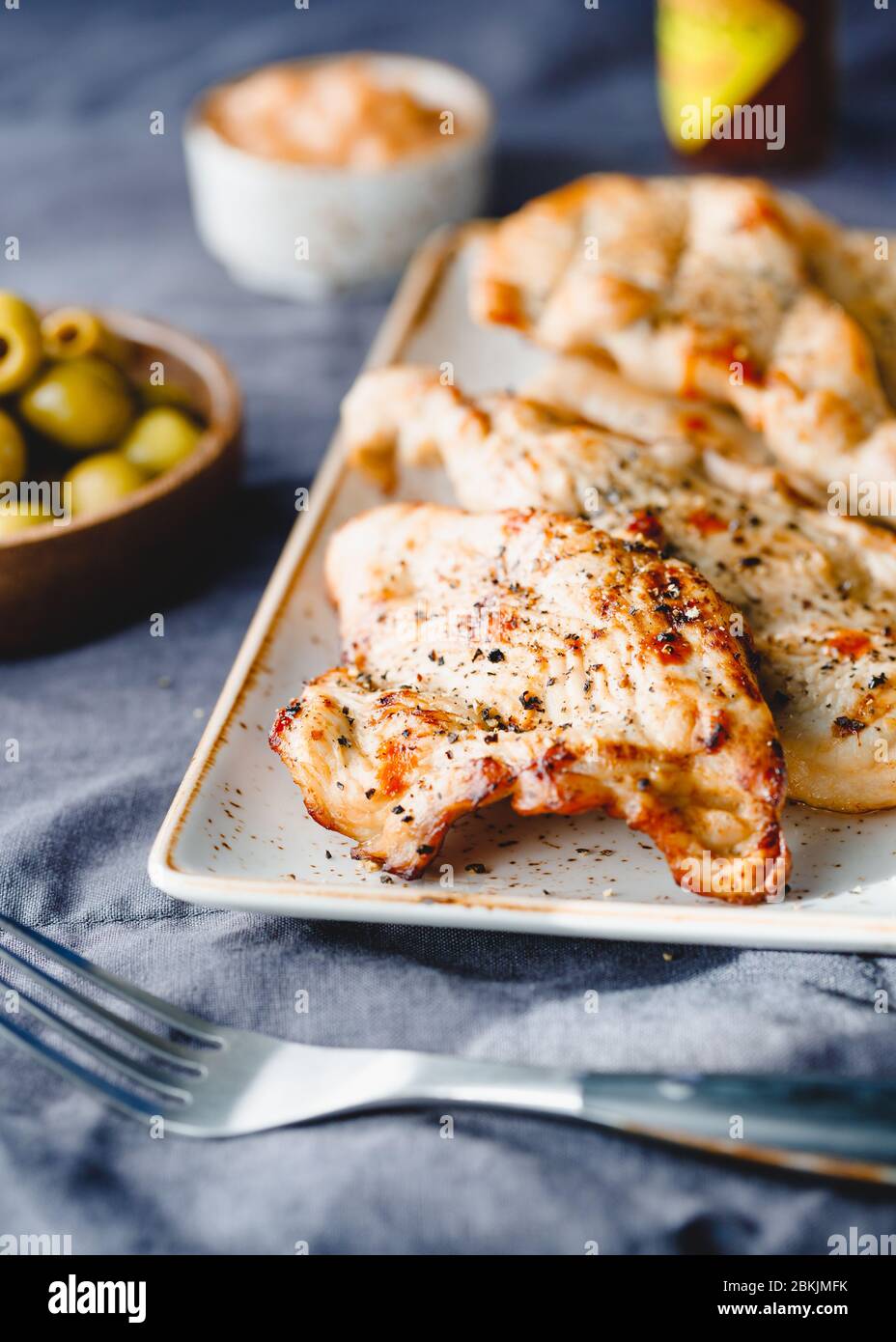 Grilled turkey escalopes with hot sauce on a table Stock Photo Alamy