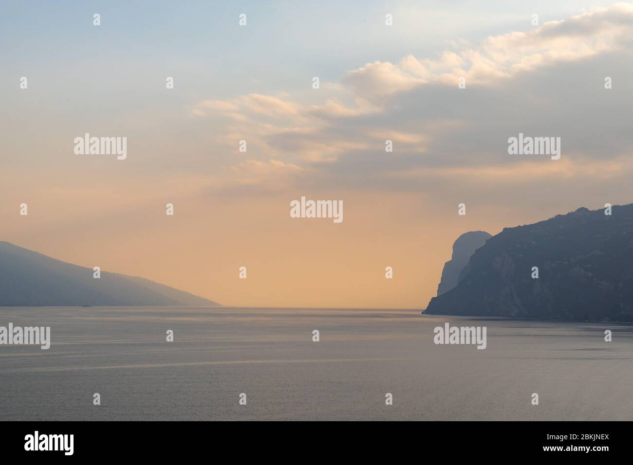 Pastel colors and minimalistic water landscape of lake Garda, northen italy. Autumn evening just after sunset, September 2019. Stock Photo