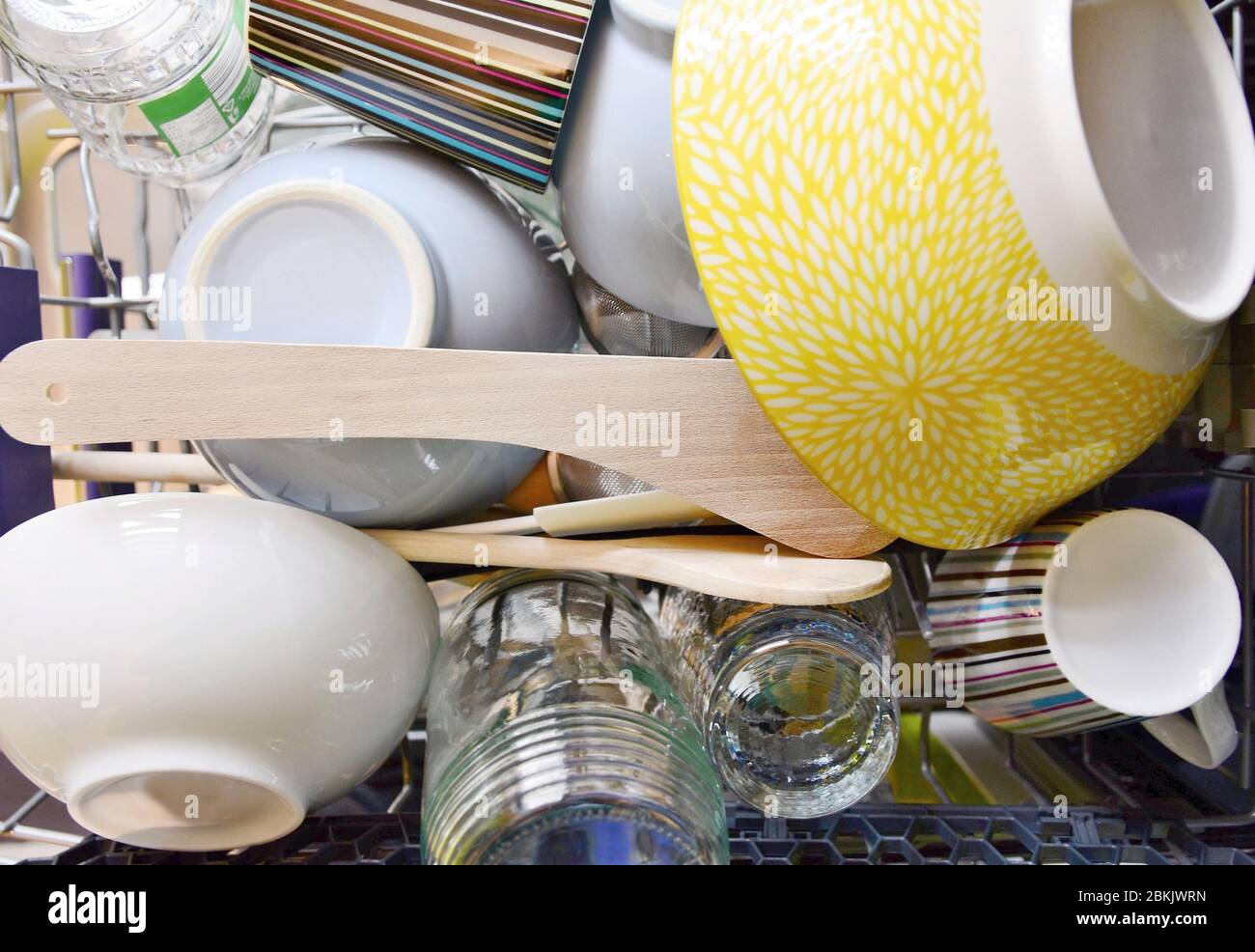 Top view of cleaned different dishes in dishwasher rack. Stock Photo
