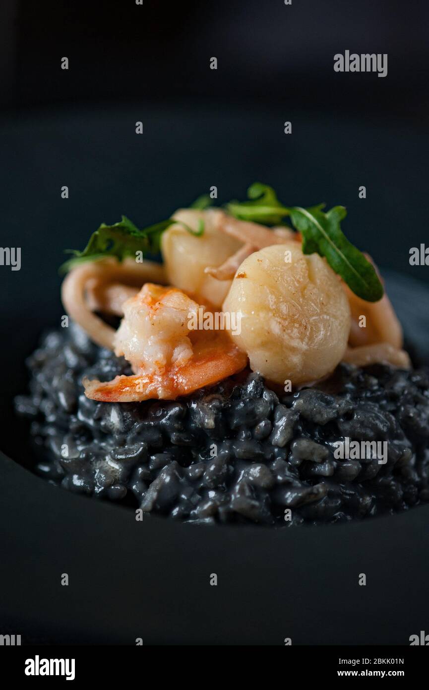 Black risotto with shrimp, scallops and cuttlefish ink Stock Photo Alamy