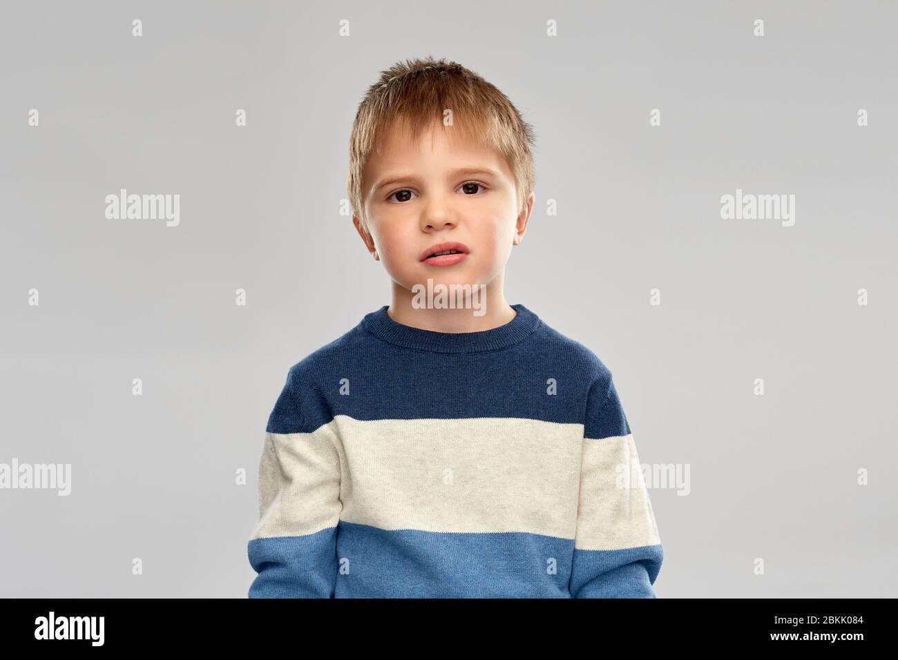 portrait of little boy in striped pullover Stock Photo