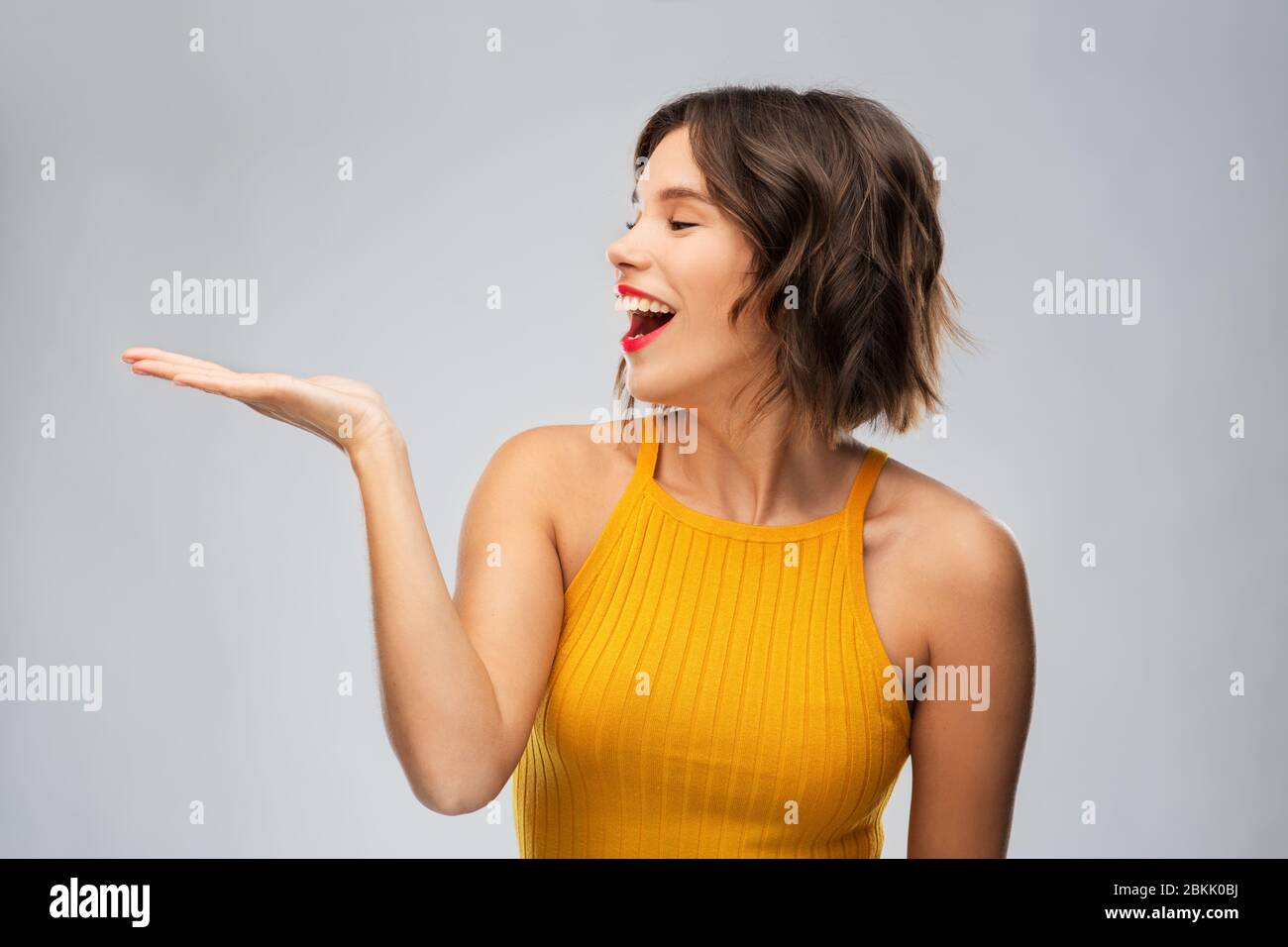 Young woman presenting hand hi-res stock photography and images - Alamy