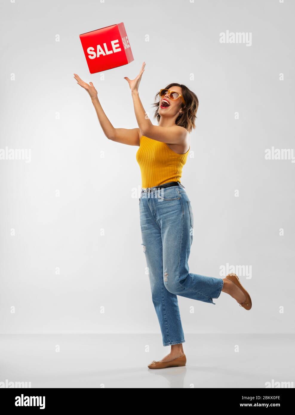 happy smiling young woman posing with sale sign Stock Photo