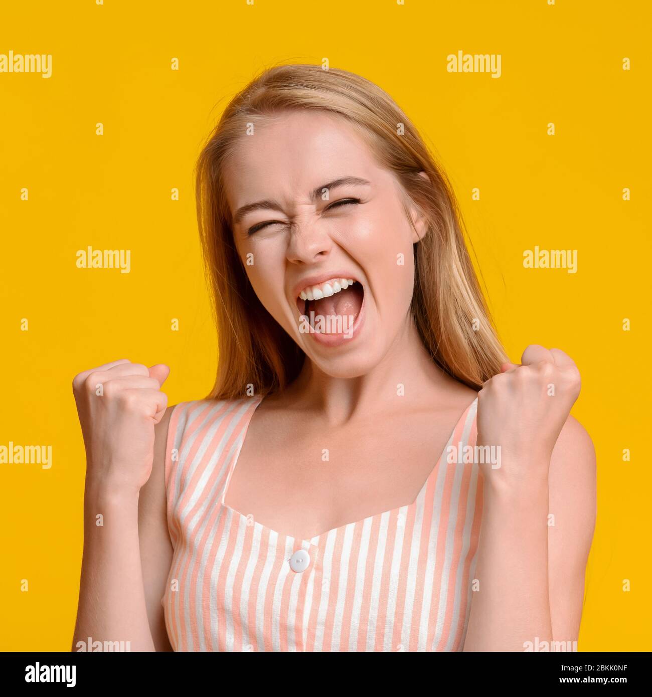 Crazy Sales. Young Girl Emotionally Shouting With Raised Fists, Celebrating Success Stock Photo