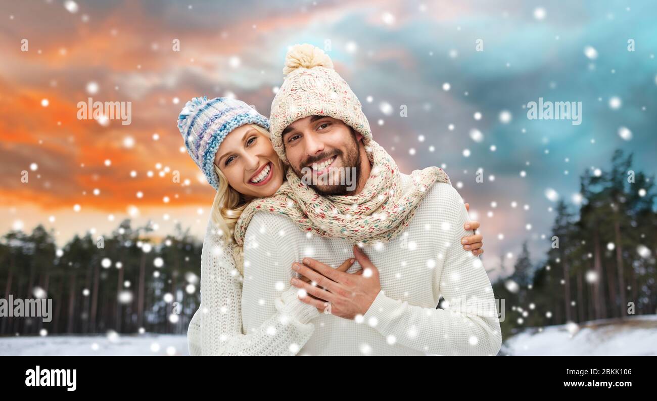 smiling couple in winter clothes hugging Stock Photo - Alamy
