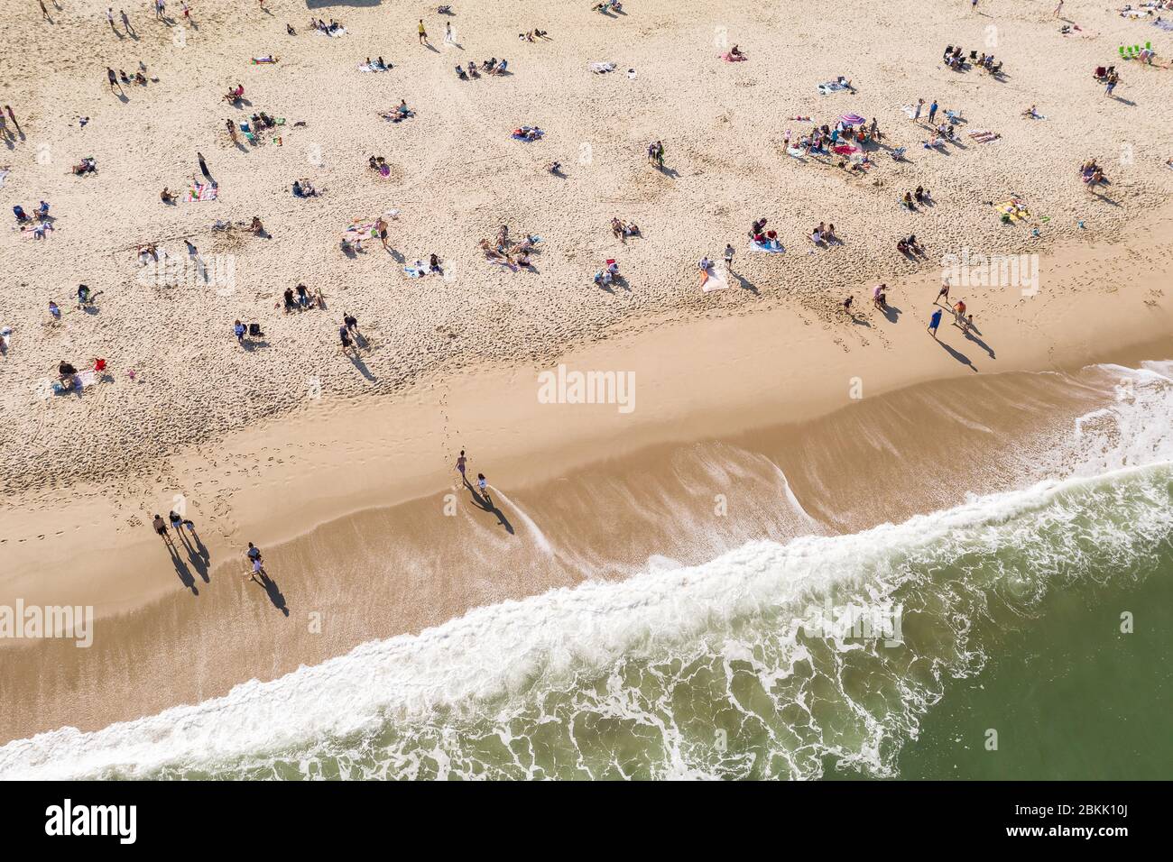 Aerial view of a crowded Jersey Shore beach in Long Branch, New Jersey.  Despite the Coronavirus pandemic beachgoers flocked to the shore amidst the warm weather and recent beach re-openings. Stock Photo
