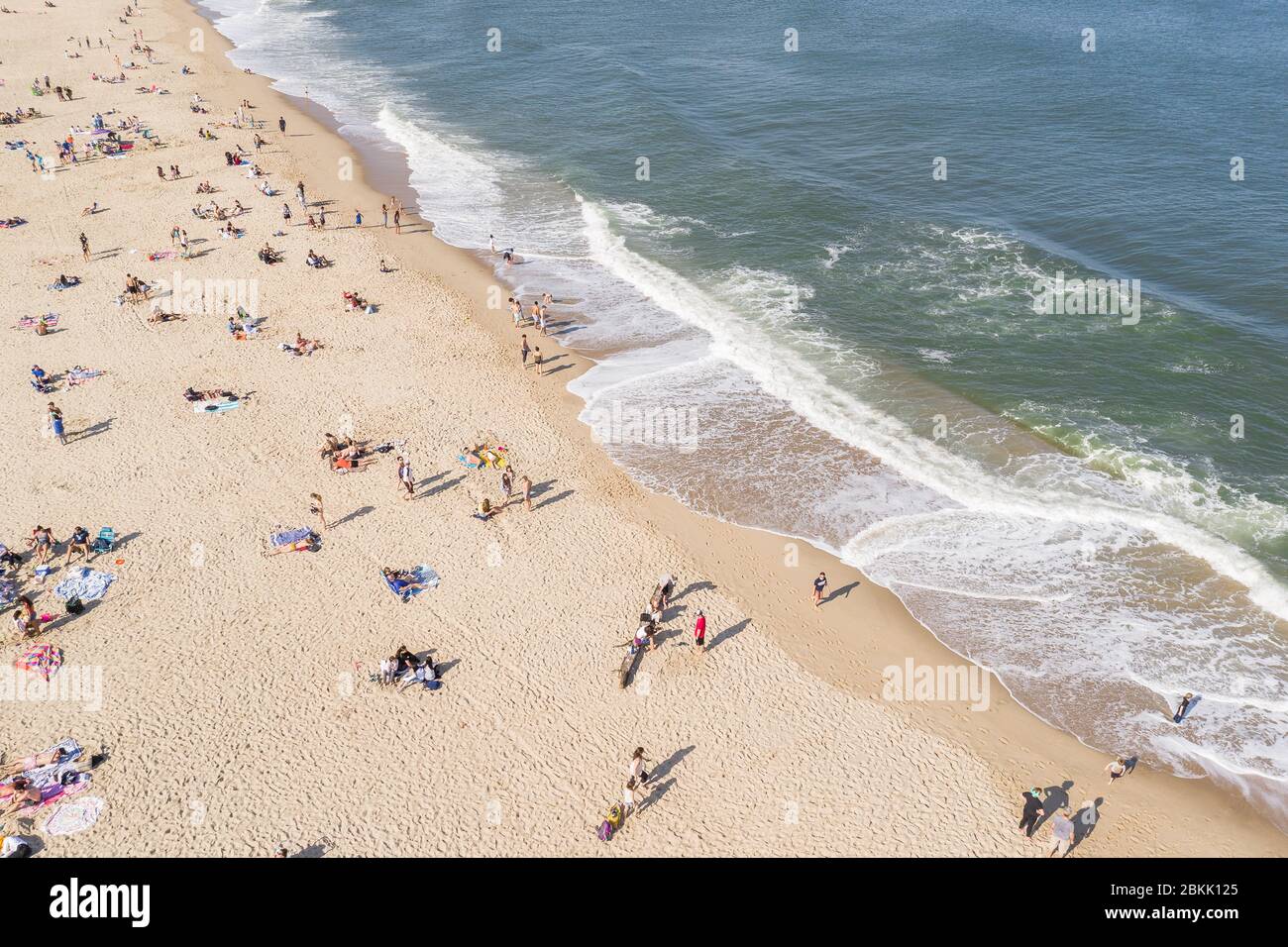 Aerial view of a crowded Jersey Shore beach in Long Branch, New Jersey.  Despite the Coronavirus pandemic beachgoers flocked to the shore amidst the  warm weather and recent beach re-openings Stock Photo -