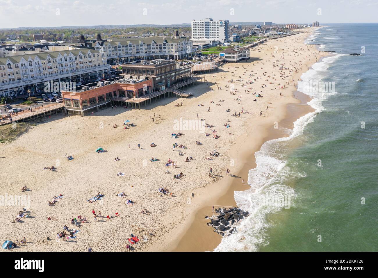 Aerial view of a crowded Jersey Shore beach in Long Branch, New Jersey.  Despite the Coronavirus pandemic beachgoers flocked to the shore amidst the warm weather and recent beach re-openings. Stock Photo