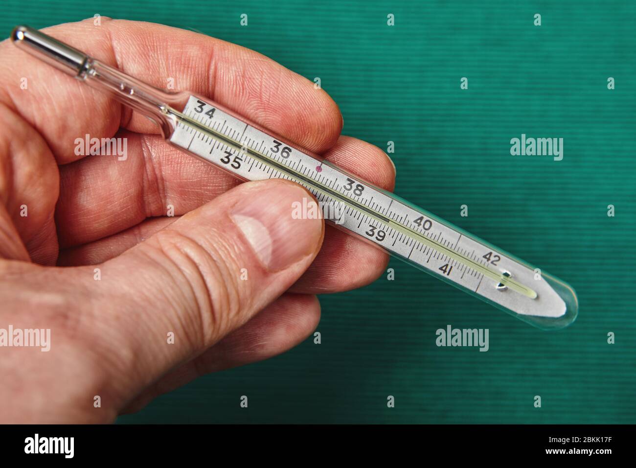 A glass mercury thermometer shows the high temperature of a persons