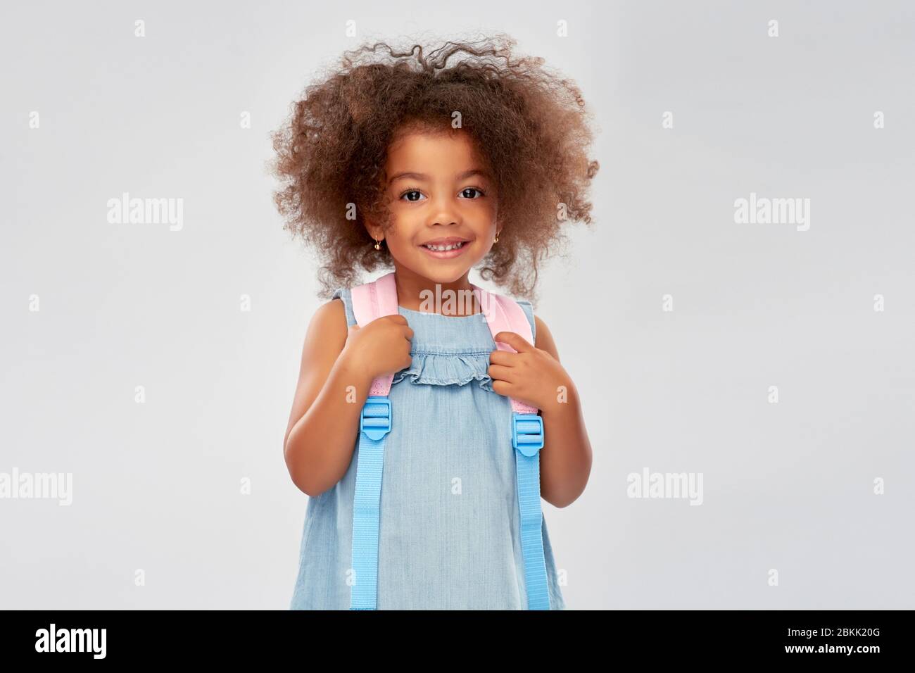 happy little african american girl with backpack Stock Photo