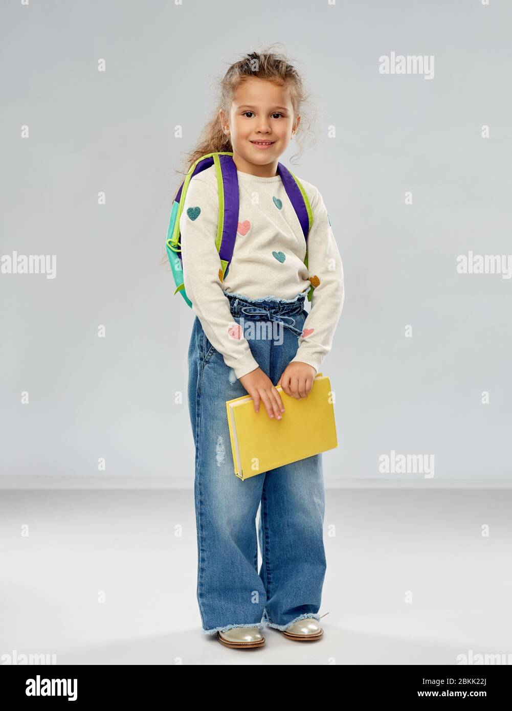 happy little girl with school backpack Stock Photo - Alamy