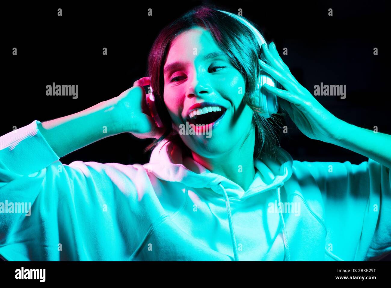 woman in headphones listening to music and dancing Stock Photo