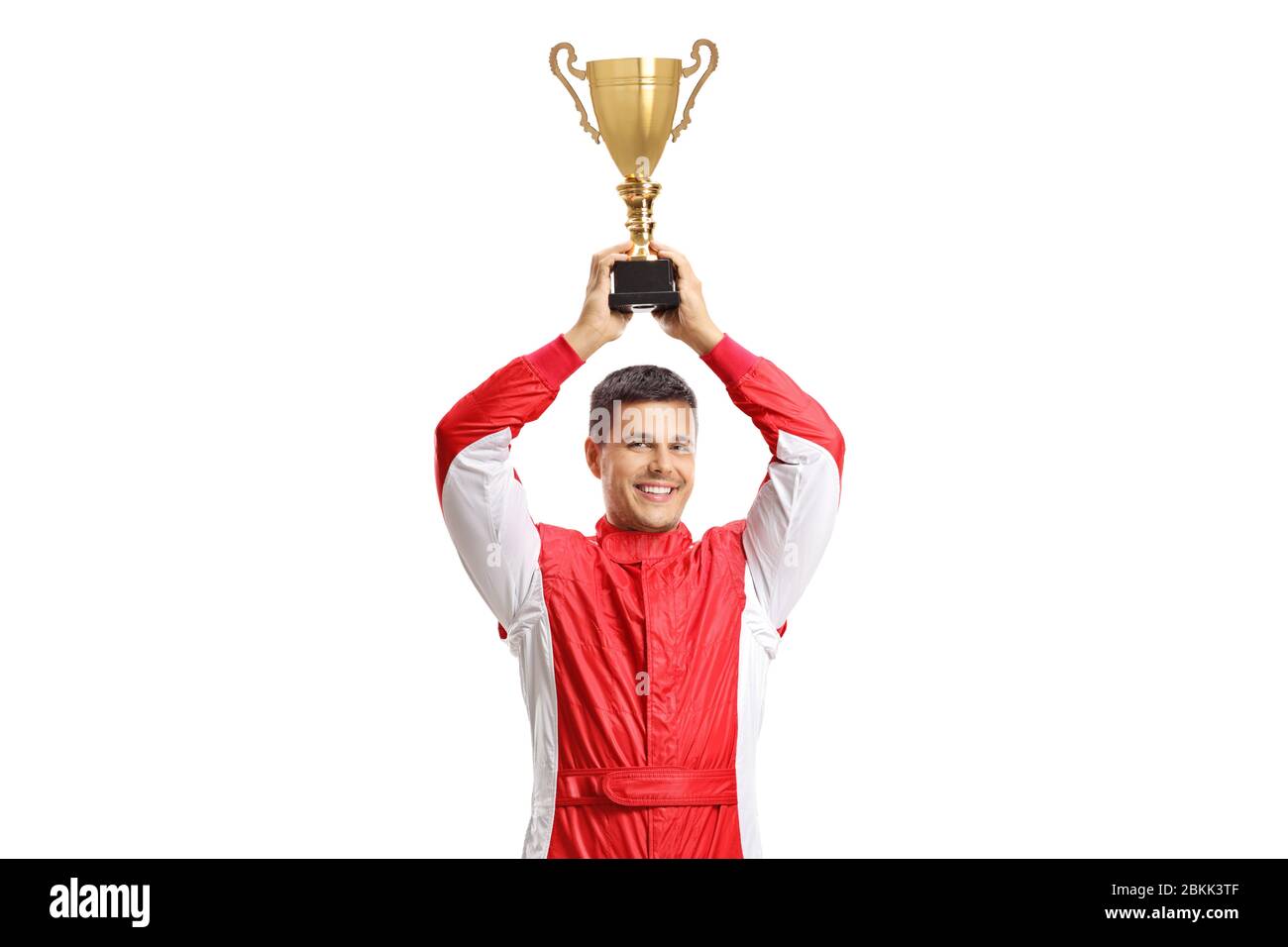Car racer holding a gold trophy cup and smiling isolated on white background Stock Photo