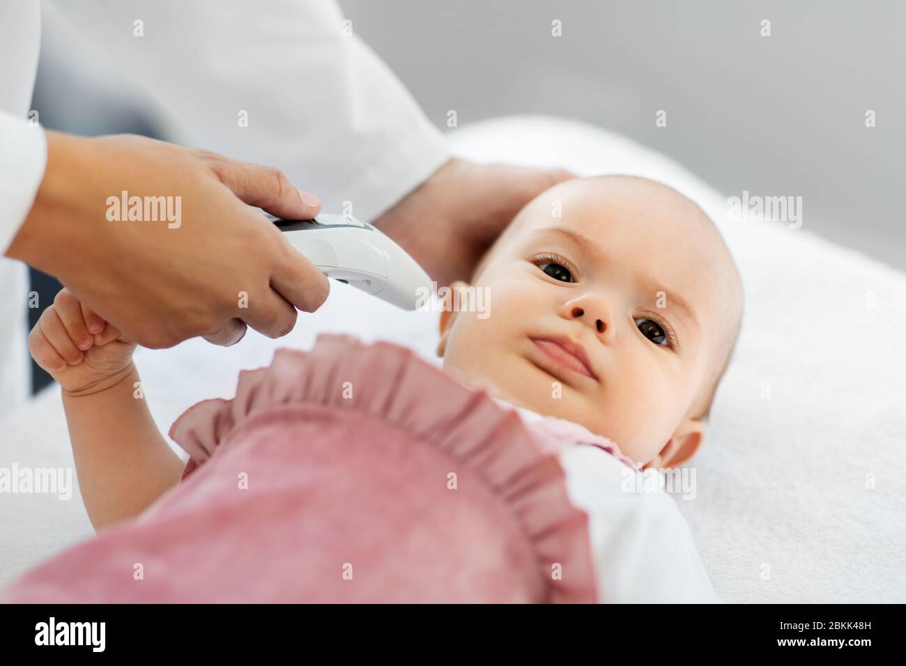 doctor with thermometer measures baby temperature Stock Photo Alamy
