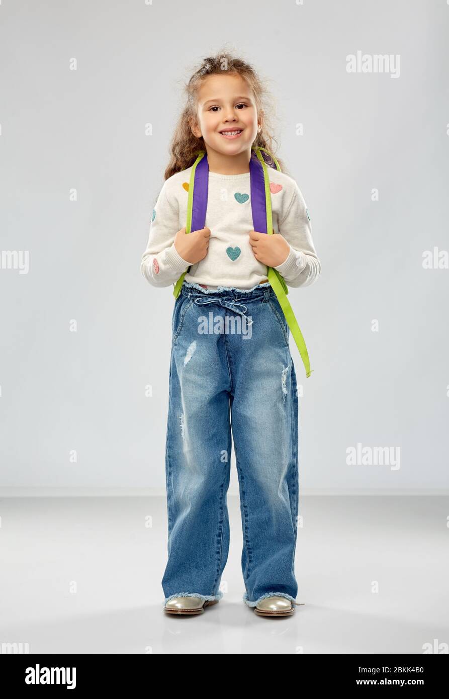 happy little girl with school backpack Stock Photo - Alamy