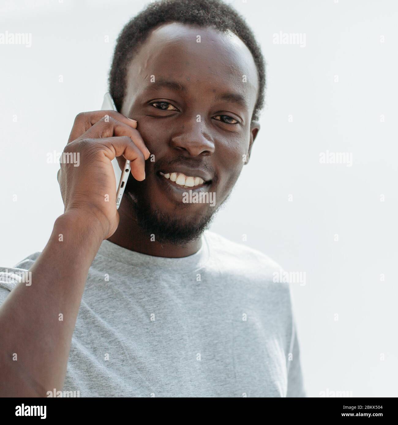side view. stylish young man talking on his smartphone. Stock Photo