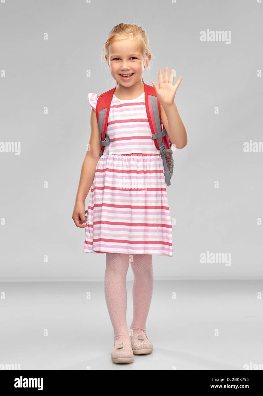 happy student girl with school bag waving hand Stock Photo - Alamy