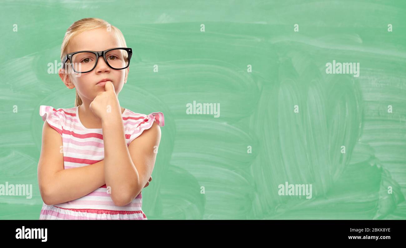cute little girl in glasses thinking at school Stock Photo - Alamy