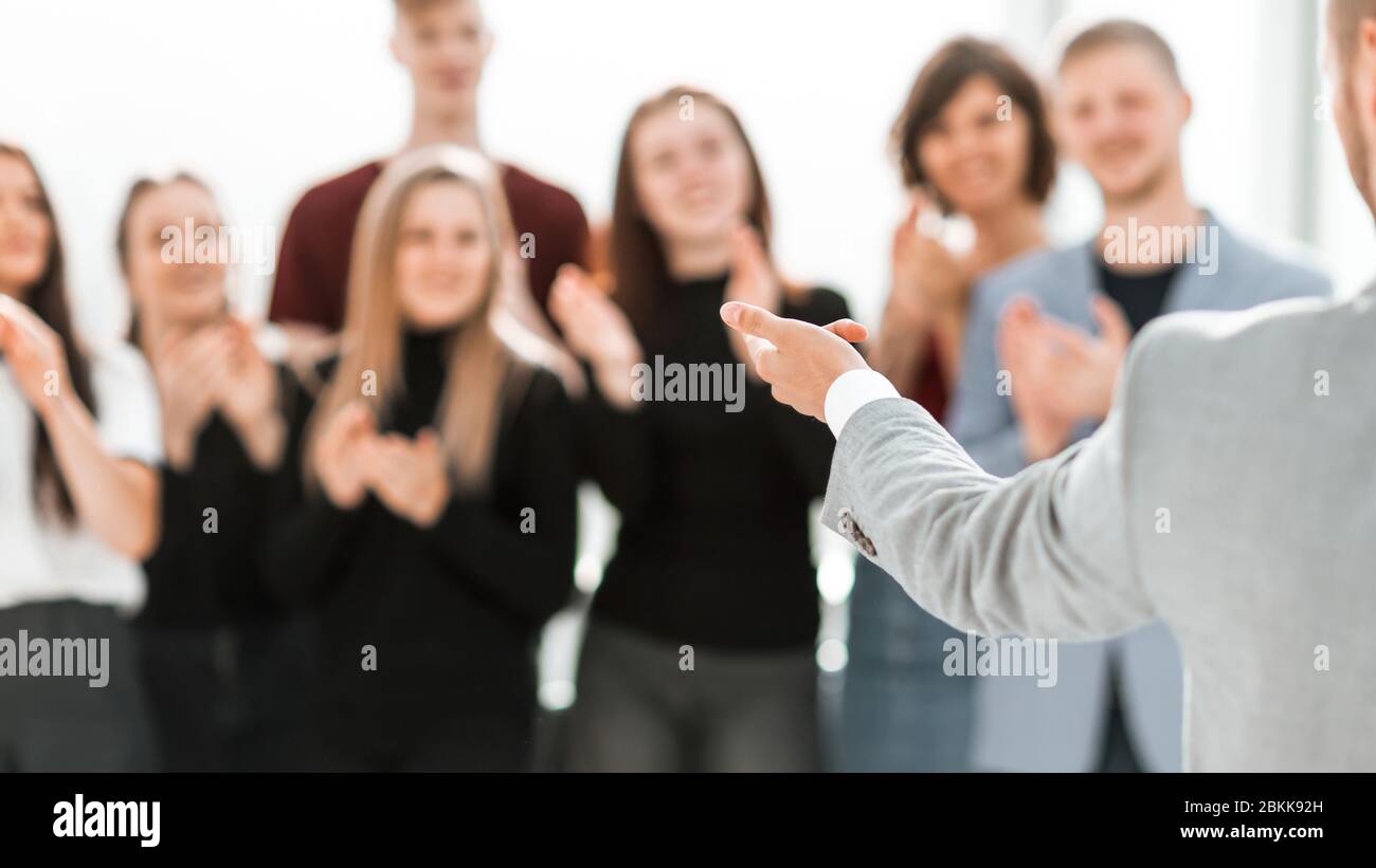 blurry image of a group of different people standing in a confe Stock Photo