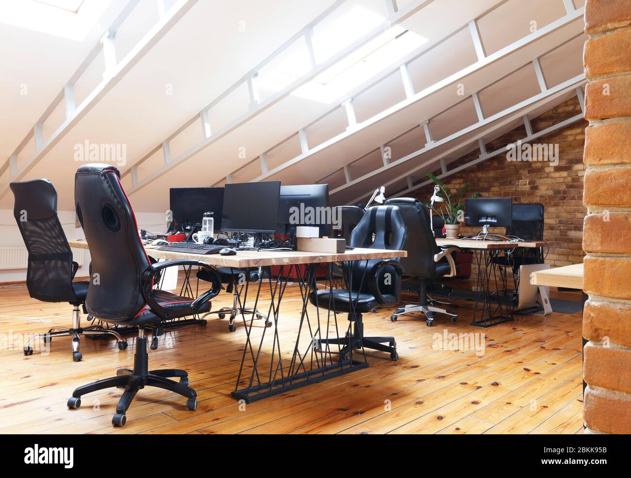 Coworking office interior with computers on desktop and furniture Stock Photo Alamy