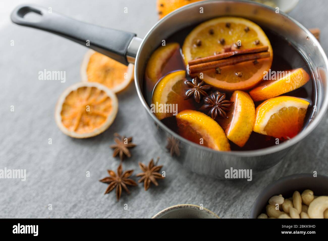pot with hot mulled wine, orange slices and spices Stock Photo