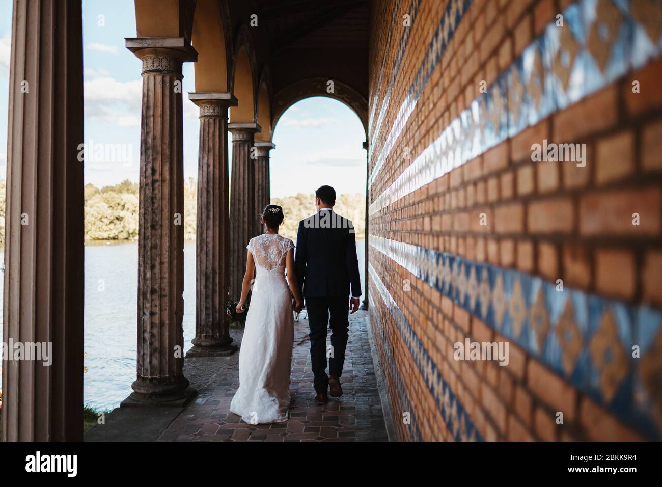 a bride and a groom in an old building Stock Photo - Alamy