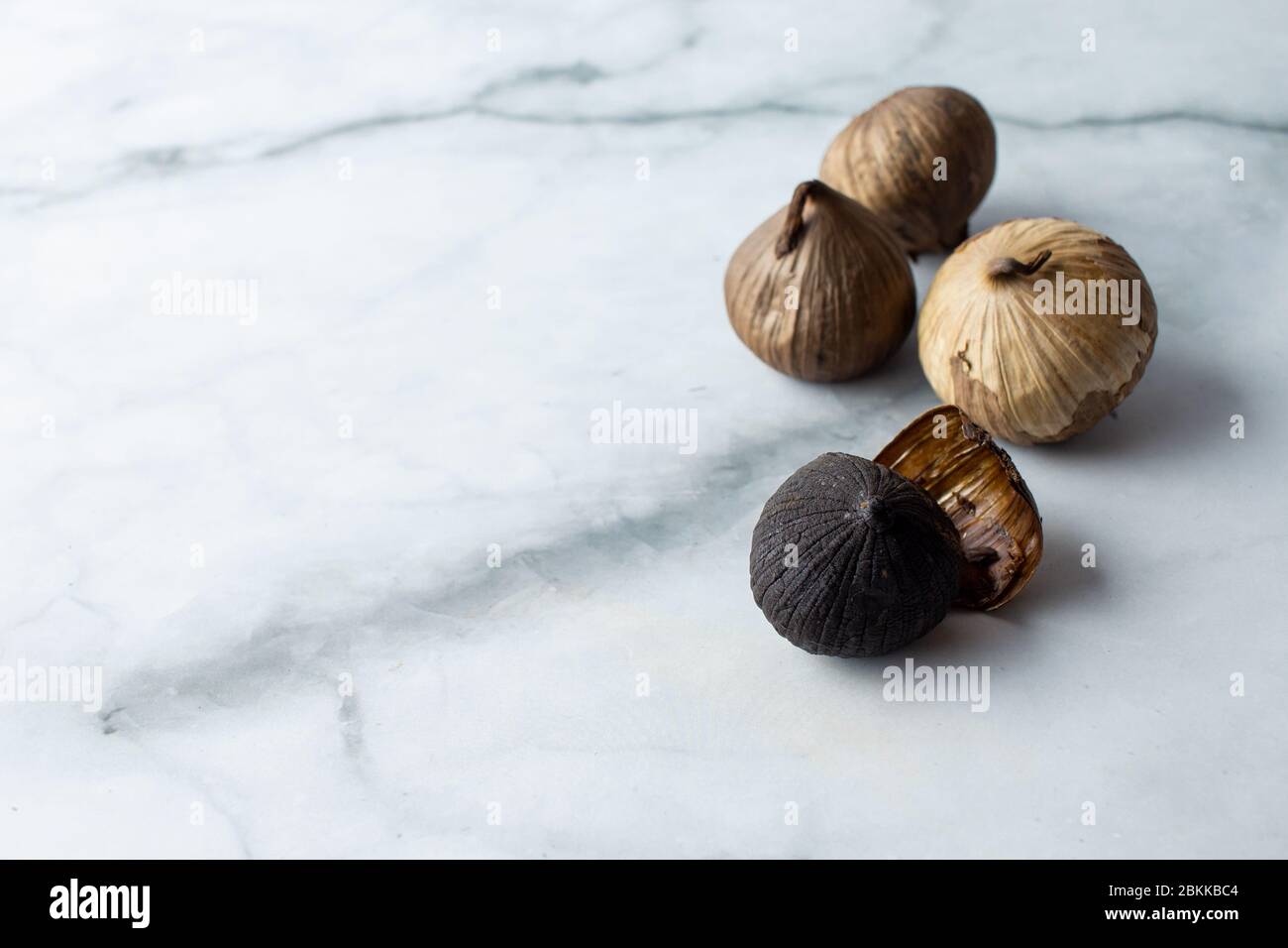 A group of black garlic, solo garlic bulb. A food ingredient, or commonly used for holistic food theraphy. Stock Photo
