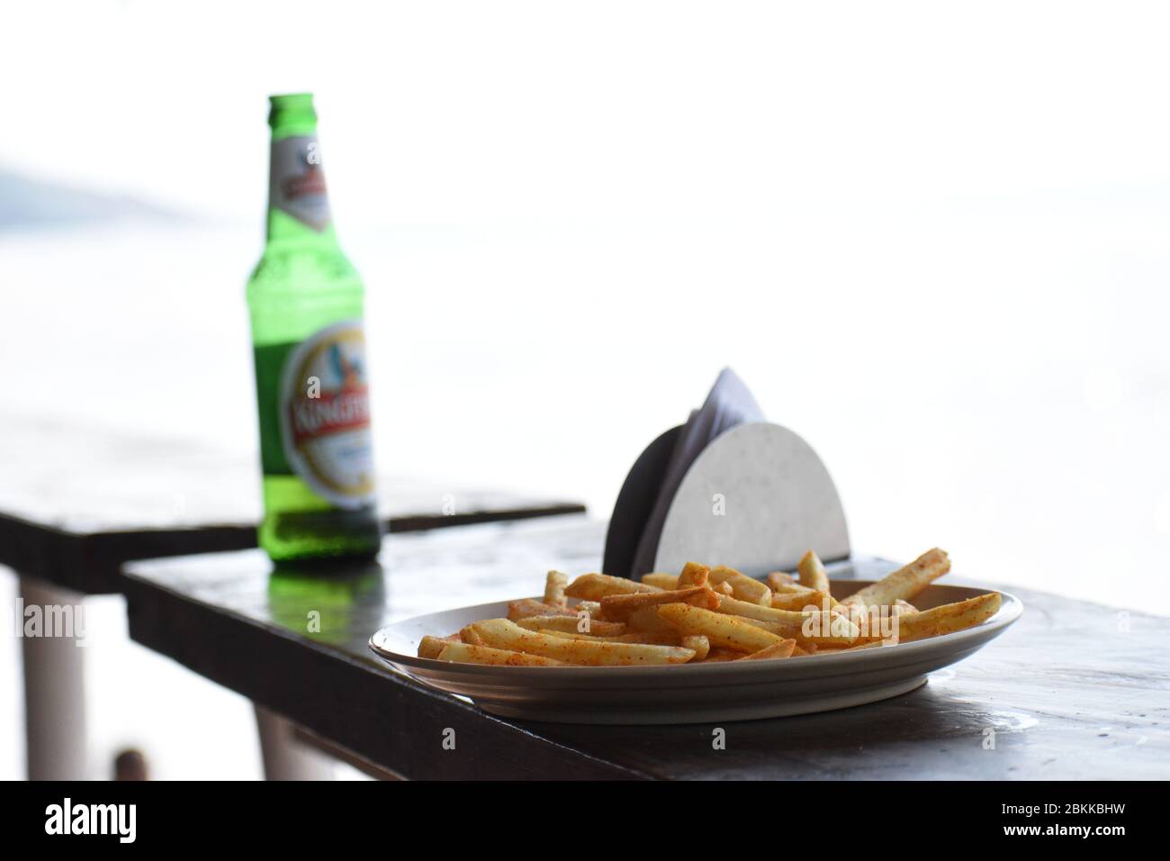 Beer and French fries in beach background. Stock Photo