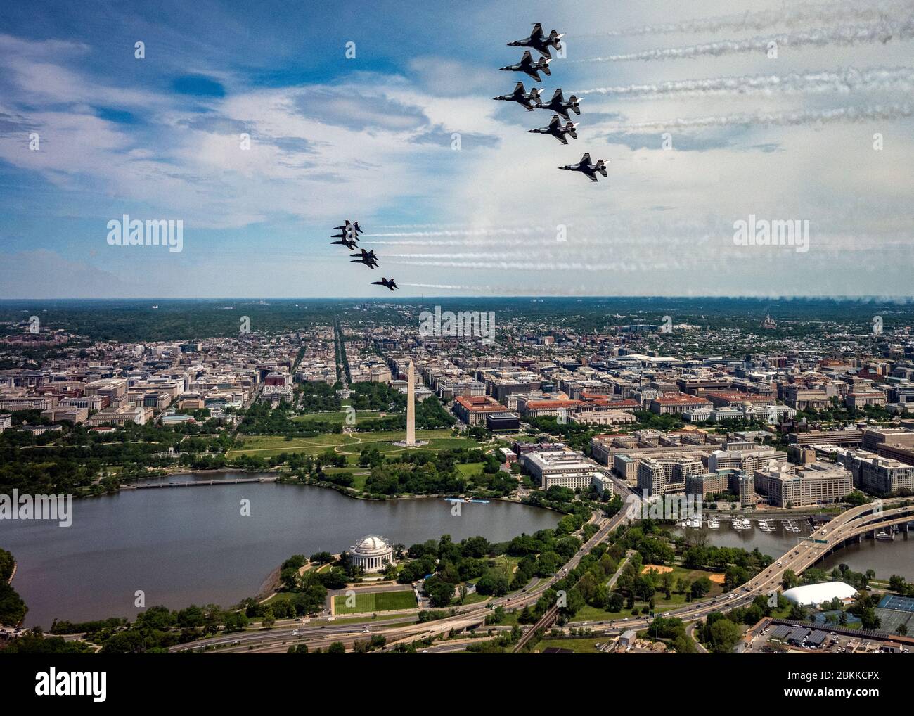 The U.S. Air Force Air Demonstration Squadron, the Thunderbirds, and the Navy Blue Angels, below, fly in formation over the Washington Monument and Jefferson Memorial, during the America Strong flyover May 2, 2020 in Washington, D.C. America Strong is a salute from the Navy and Air Force to recognize healthcare workers, first responders, and other essential personnel in a show of national solidarity during the COVID-19 pandemic. Stock Photo