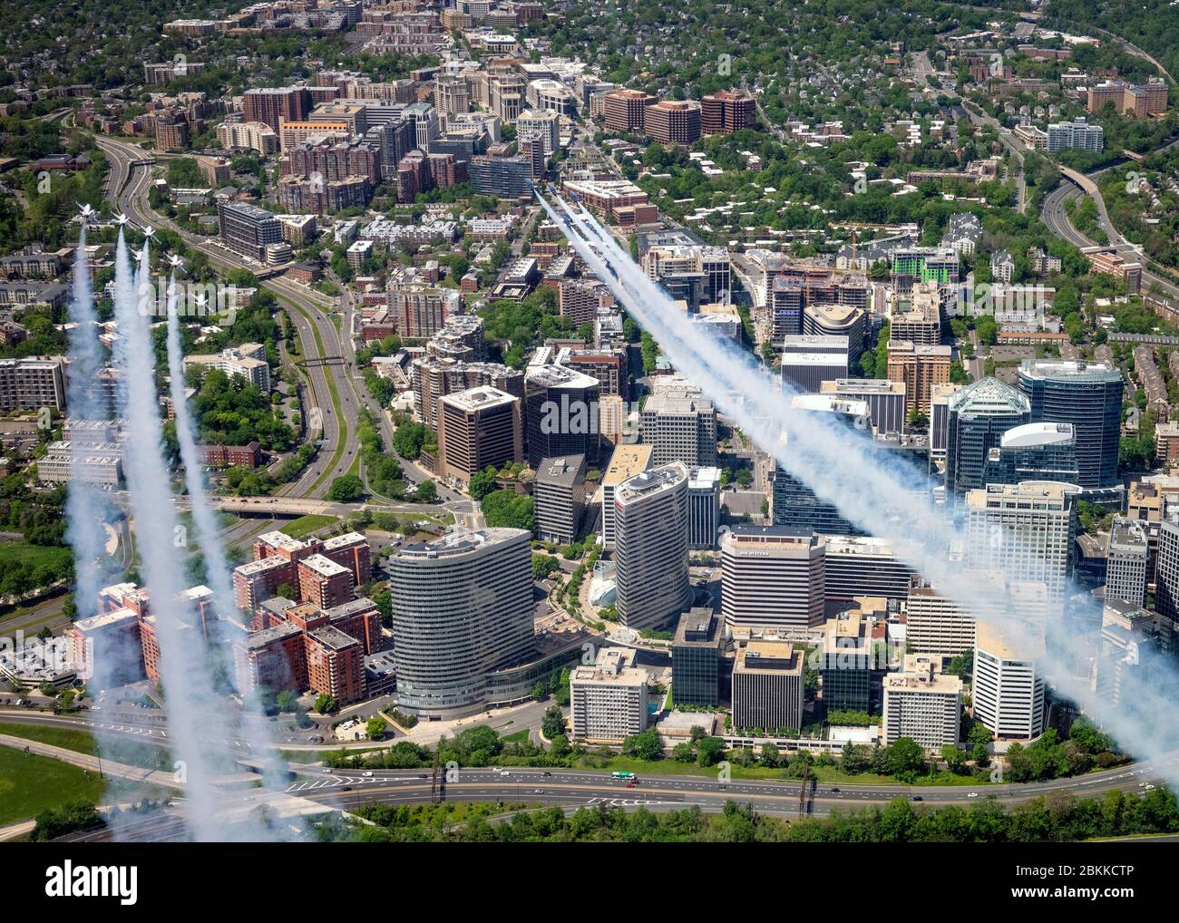 The U.S. Air Force Air Demonstration Squadron, the Thunderbirds, and the Navy Blue Angels, right, fly in formation over Rosslyn, during the America Strong flyover May 2, 2020 in Arlington, Virginia. America Strong is a salute from the Navy and Air Force to recognize healthcare workers, first responders, and other essential personnel in a show of national solidarity during the COVID-19 pandemic. Stock Photo
