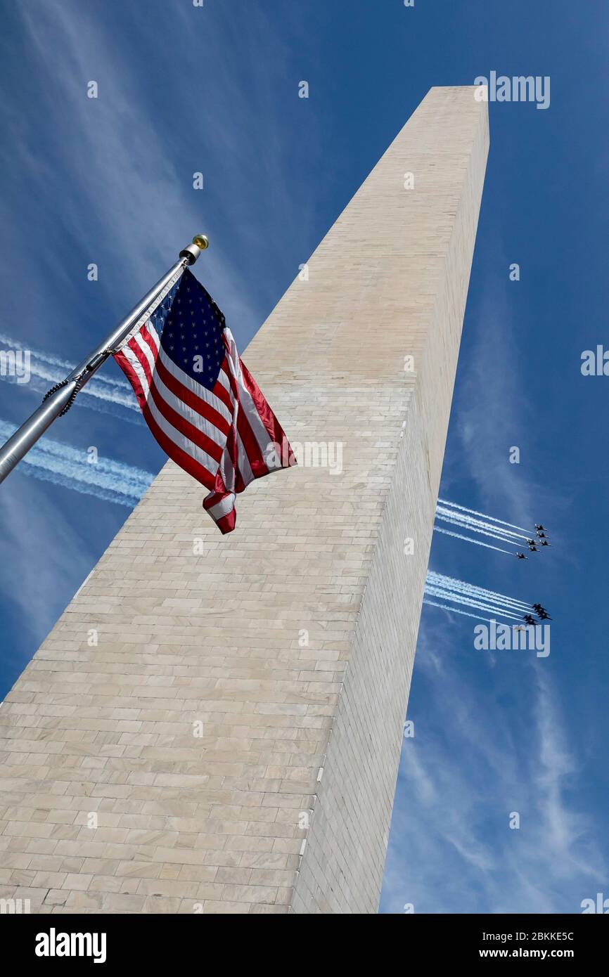The U.S. Air Force Air Demonstration Squadron, the Thunderbirds, and the Navy Blue Angels, right, fly in formation over the Washington Monument, during the America Strong flyover May 2, 2020 in Washington, D.C. America Strong is a salute from the Navy and Air Force to recognize healthcare workers, first responders, and other essential personnel in a show of national solidarity during the COVID-19 pandemic. Stock Photo