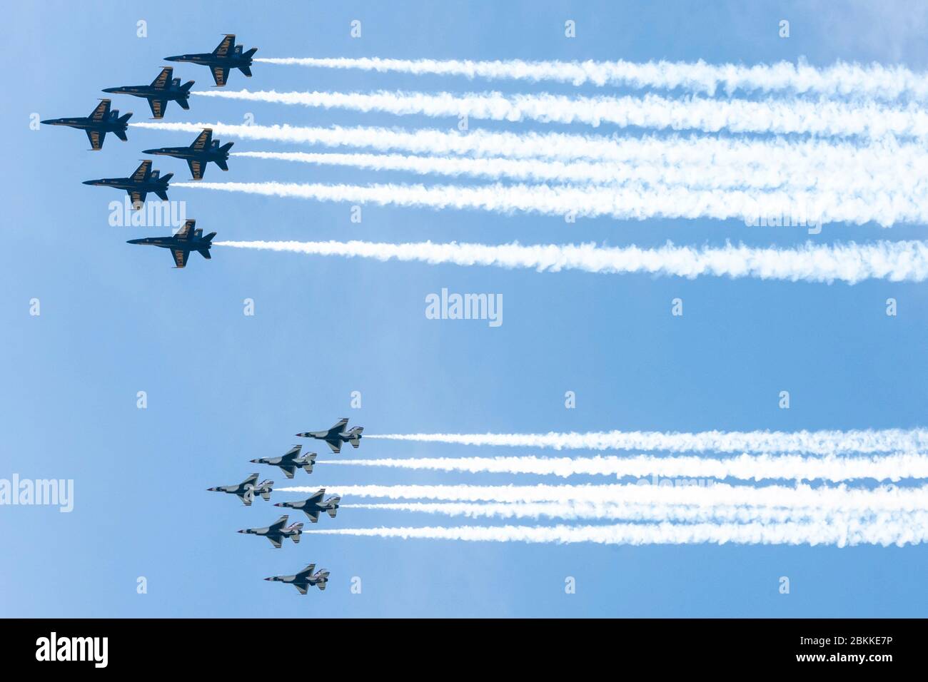 The U.S. Air Force Air Demonstration Squadron, the Thunderbirds, and the Navy Blue Angels, top, fly in formation over the Washington Monument, during the America Strong flyover May 2, 2020 in Washington, D.C. America Strong is a salute from the Navy and Air Force to recognize healthcare workers, first responders, and other essential personnel in a show of national solidarity during the COVID-19 pandemic. Stock Photo