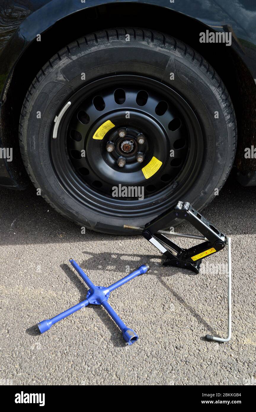 A spare tire and lug wrench and jack, following a tire puncture Stock