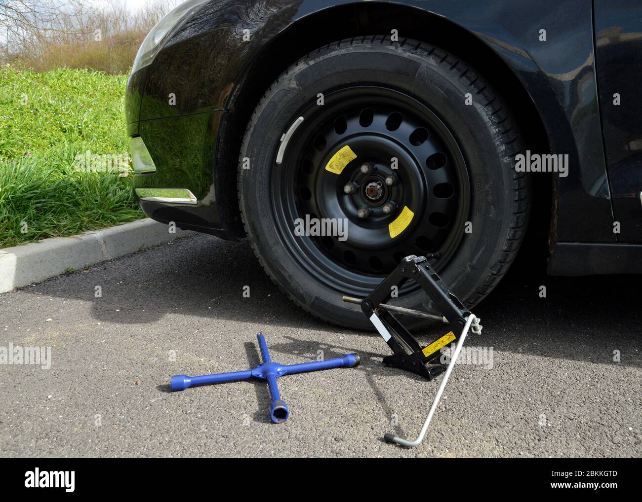 A spare tire and lug wrench and jack, following a tire puncture Stock