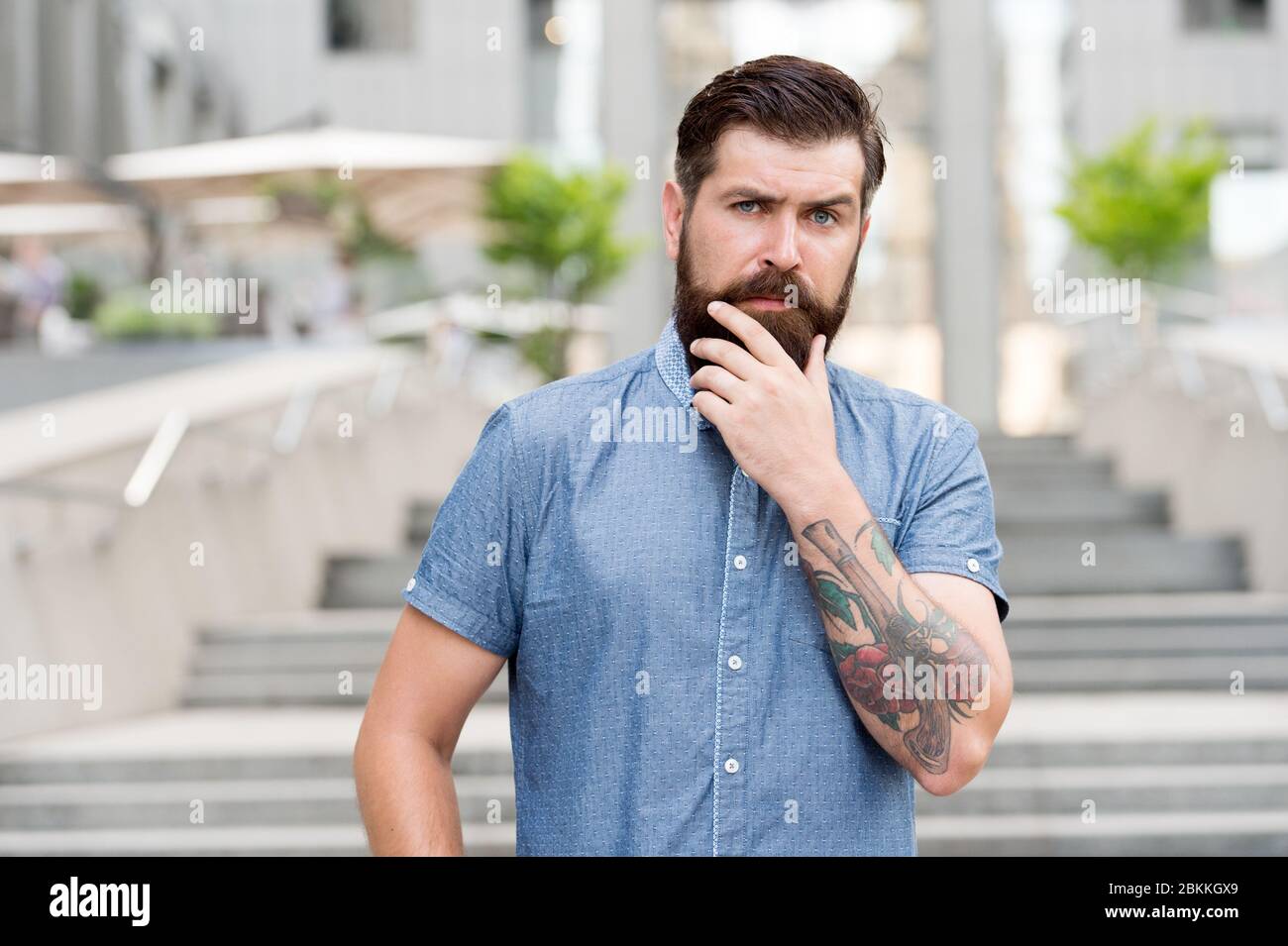 My beard my look. Bearded man touch beard urban outdoor. Hipster wear unshaven beard and mustache. Beard growth products. Barbershop. Hair salon. Mens grooming. Keep your facial hair and skin soft Stock My beard my look. Bearded man touch beard urban outdoor. Hipster wear unshaven beard and mustache. Beard growth products. Barbershop. Hair salon. Mens grooming. Keep your facial hair and skin soft Stock