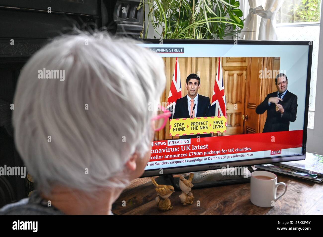 Rishi Sunak, Chancellor of the Exchequer on the televised daily government Covid-19 press conference; watched by a viewer. Stock Photo