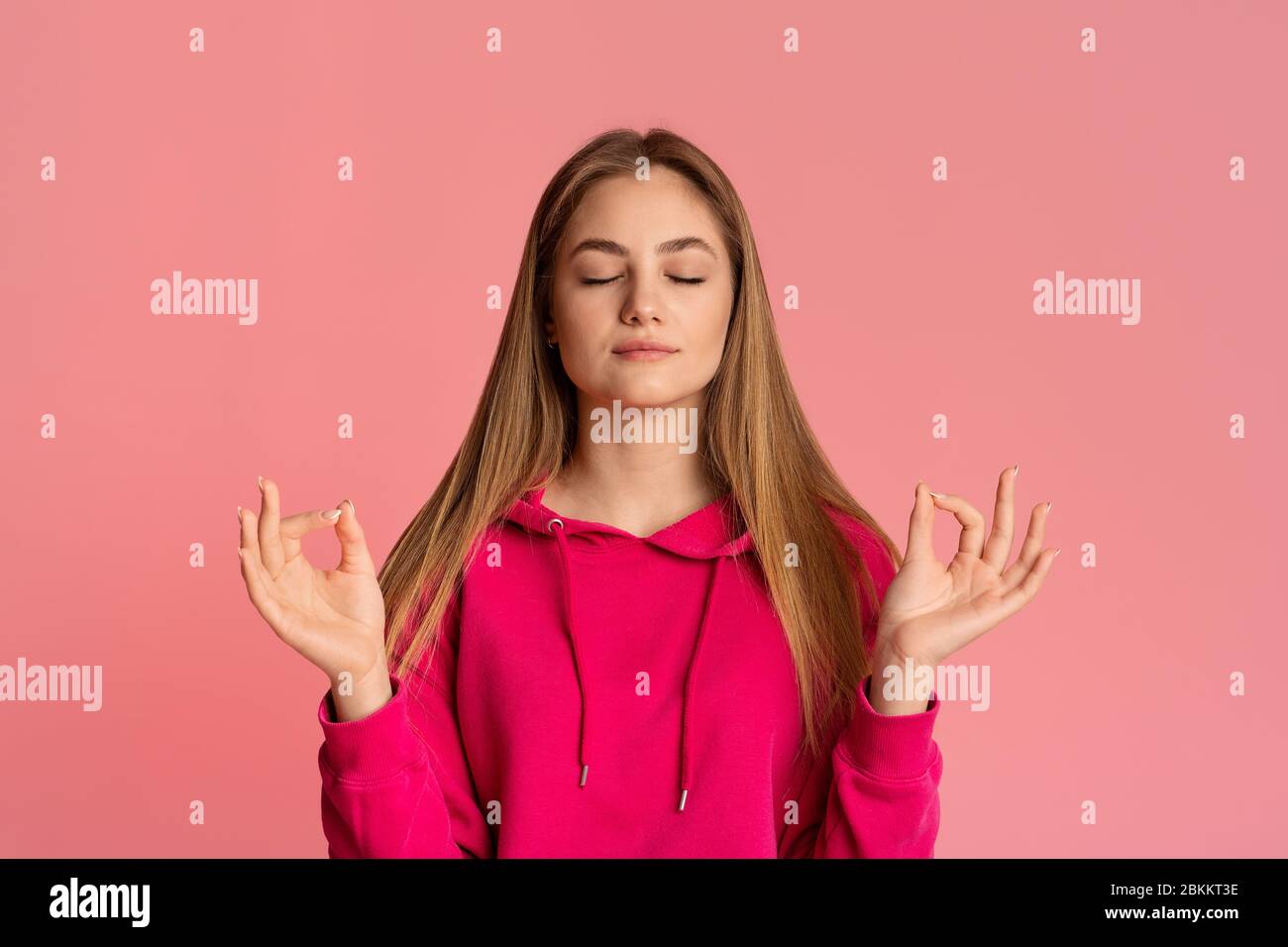 Teenage girl meditates with closed eyes, empty space Stock Photo