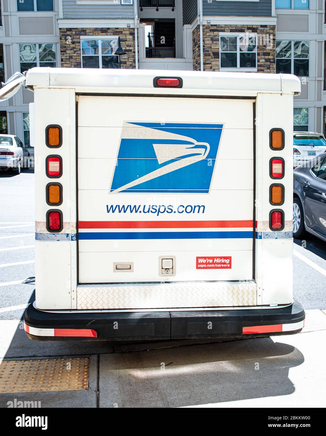 Charlottesville, Virginia , United States May 4, 2020 Postal Service truck parked in apartment complex on sunny day Stock Photo