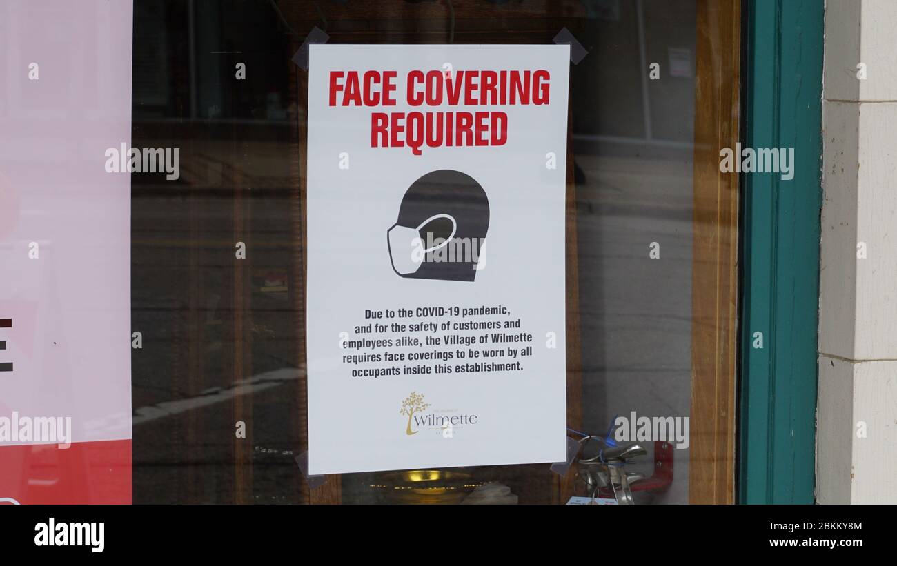 Face Covering Required - sign in the window of a business in a Chicago suburb Stock Photo