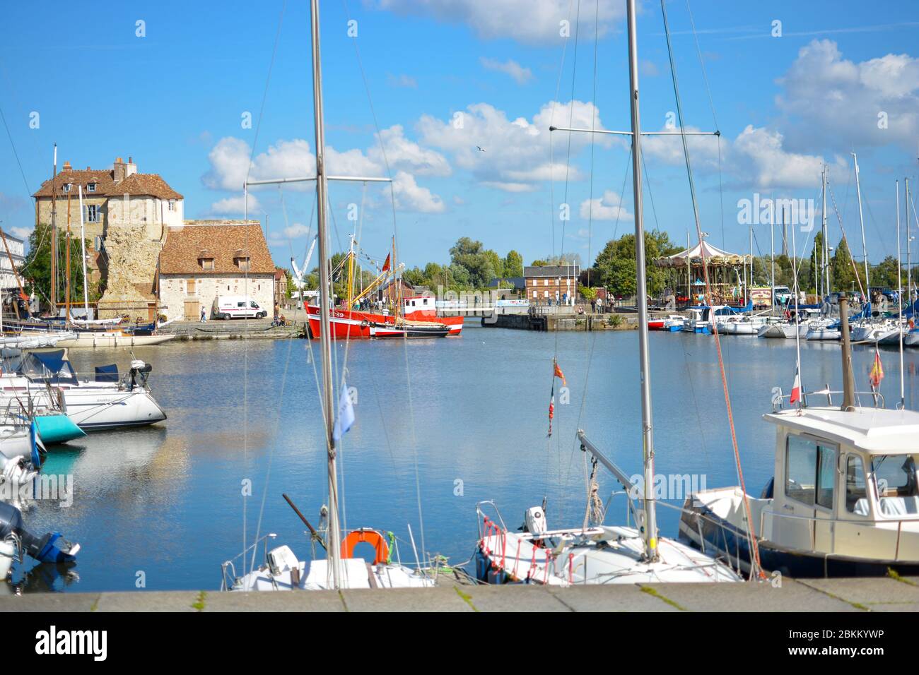 Boats, yachts and fishing vessels line the old harbor or Vieux Bassin in the charming Normandy village of Honfleur, France Stock Photo
