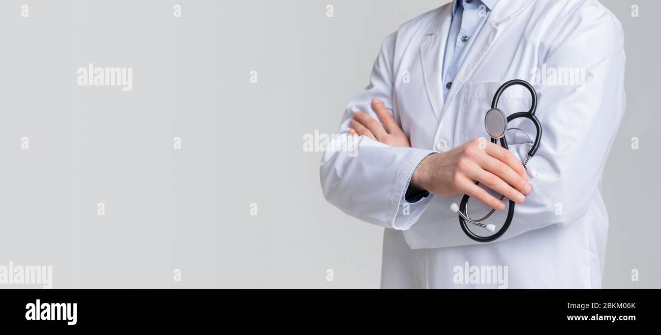 Medical Support. Male Doctor Holding Stethoscope While Posing With Folded Arms Stock Photo