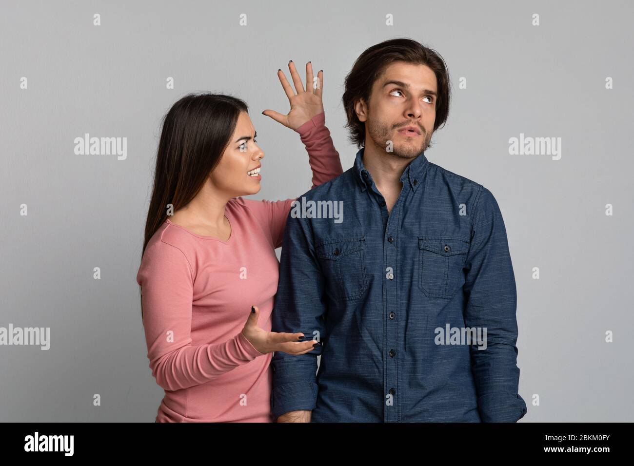 PMS Syndrome. Angry Young Woman Emotionally Screaming At Annoyed Husband Stock Photo