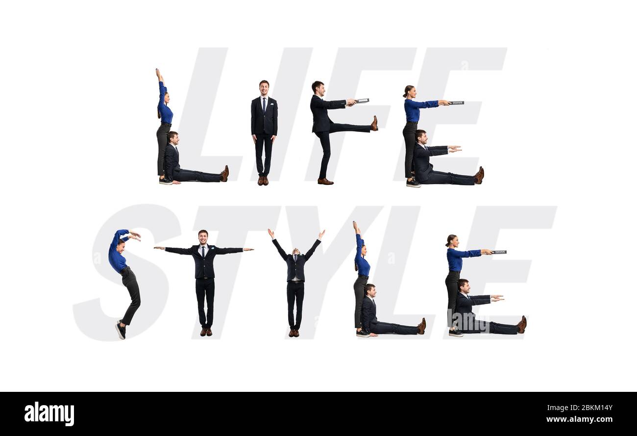 Group of workers forming Life Style phrase at studio Stock Photo